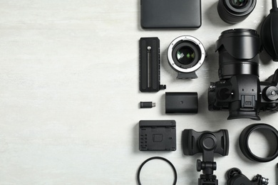 Photo of Camera and video production equipment on light background, flat lay. Space for text