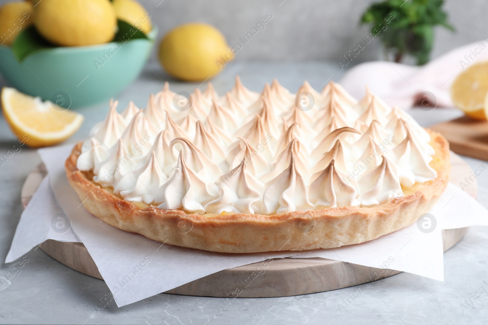 Photo of Delicious lemon meringue pie on grey table