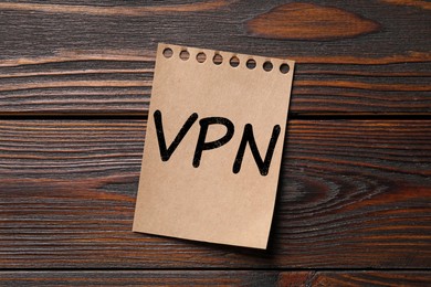 Paper sheet with acronym VPN (Virtual Private Network) on wooden table top view