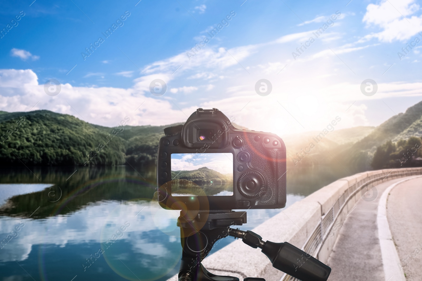 Image of Taking photo of beautiful mountain landcape and road with camera mounted on tripod