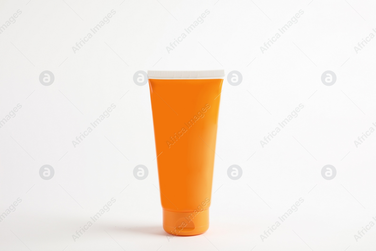 Photo of Tube with sun protection body cream on white background