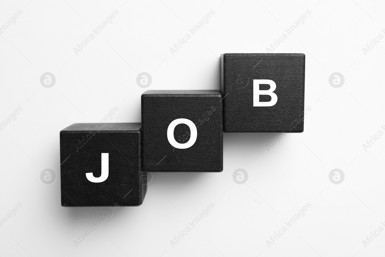 Photo of Black cubes with word JOB on white background, top view. Career concept
