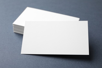 Photo of Blank business cards on dark grey background, closeup. Mock up for design