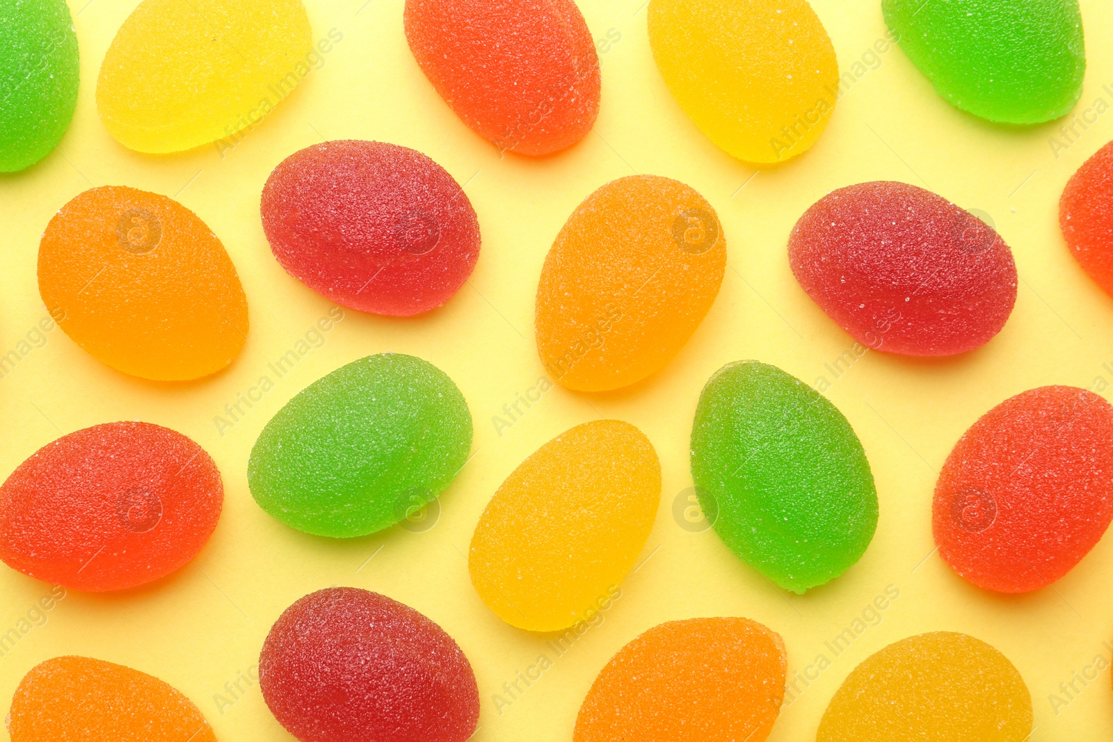 Photo of Tasty bright jelly candies on color background, flat lay