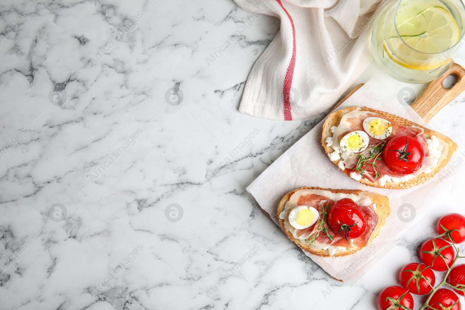 Photo of Flat lay composition with delicious bruschettas on white marble table, space for text