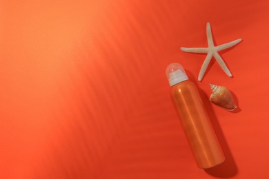 Sunscreen, seashell and starfish on coral background, flat lay and space for text. Sun protection care