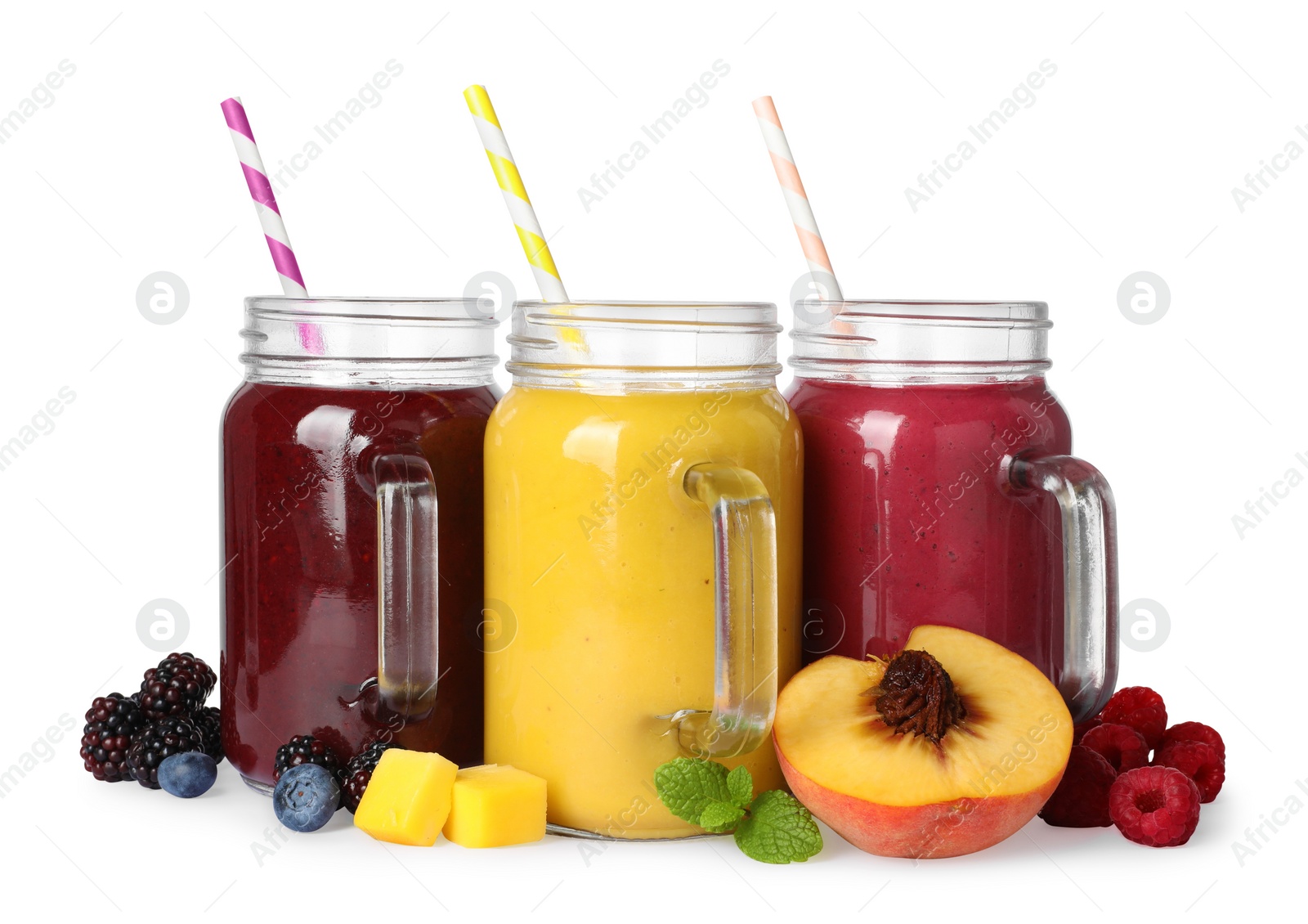 Photo of Different tasty smoothies in mason jars isolated on white