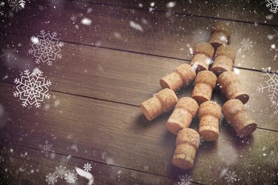 Christmas tree made of sparkling wine corks on wooden table. Space for text