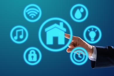 Image of Man using digital screen with Smart Home interface on blue background, closeup