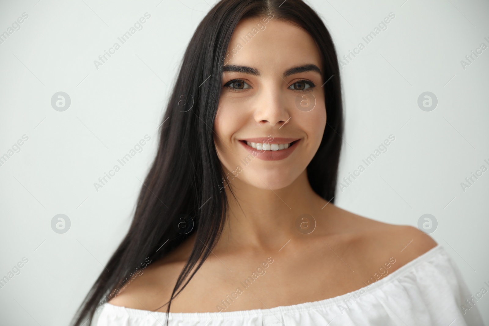 Photo of Beautiful young woman on light grey background