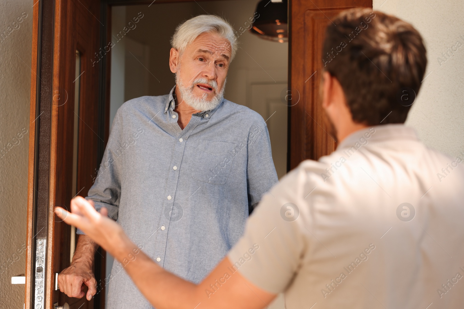 Photo of Emotional neighbours having argument near house outdoors