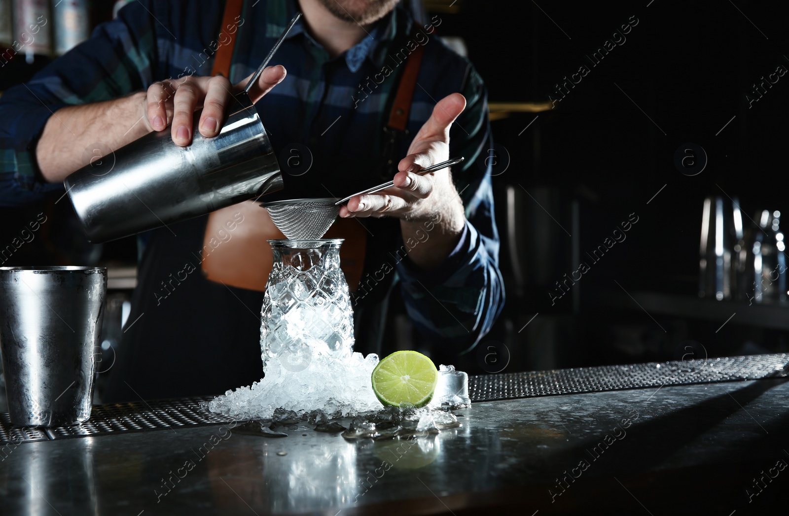 Photo of Barman making tropical cocktail at counter in pub, closeup. Space for text