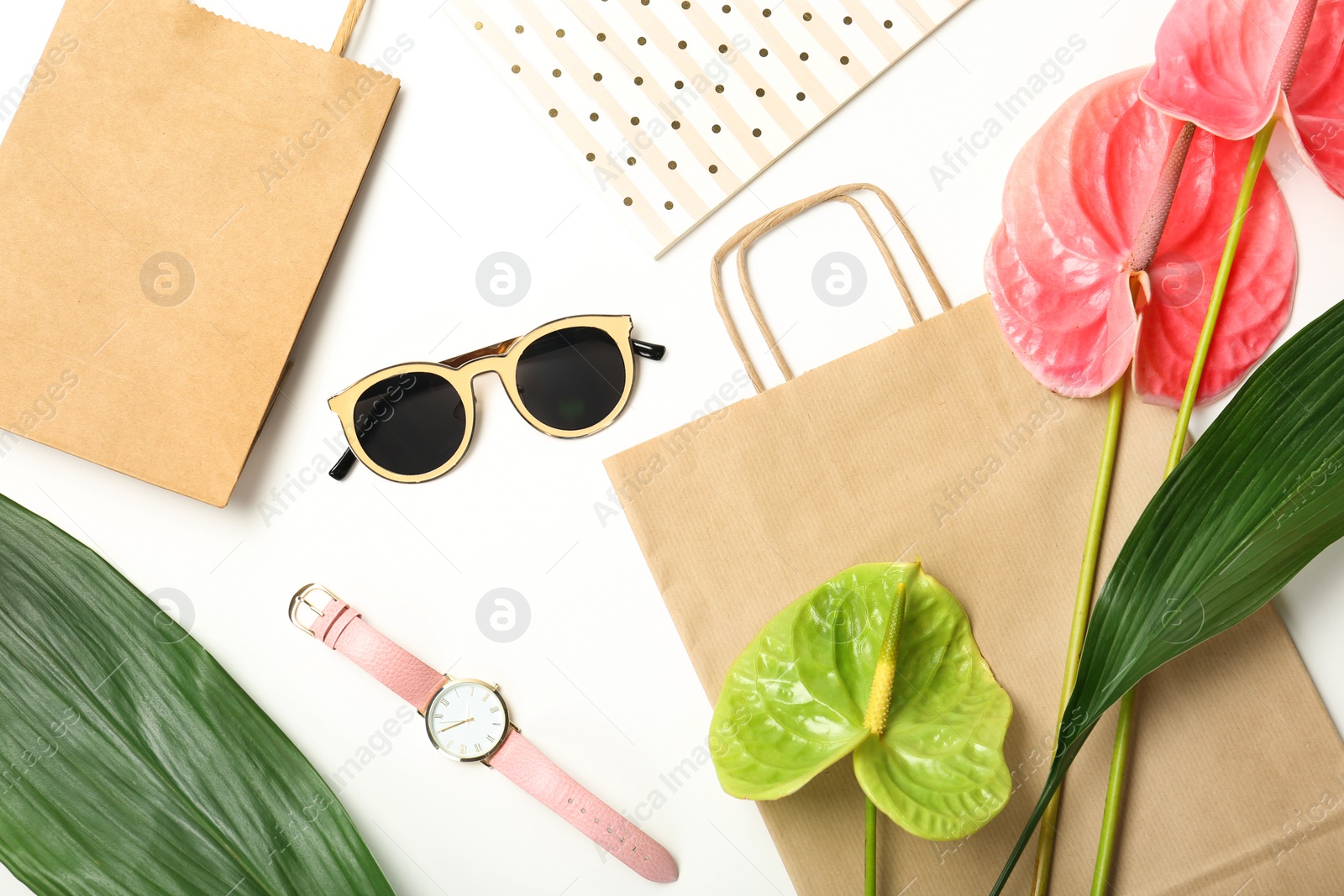 Photo of Stylish flat lay composition with shopping bags on white background