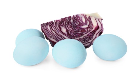 Photo of Light blue Easter eggs painted with natural dye and red cut cabbage on white background