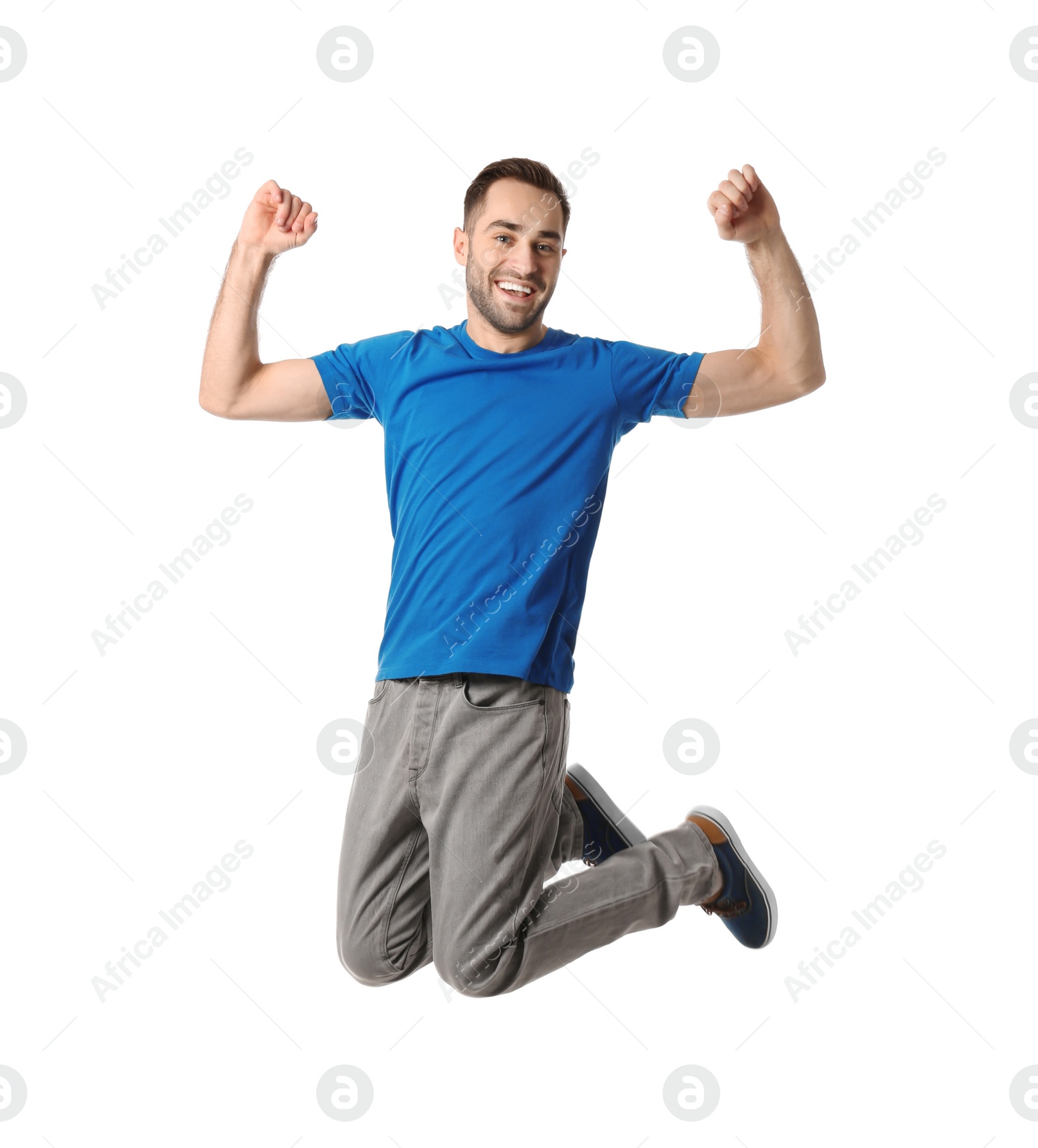 Photo of Full length portrait of happy handsome man jumping on white background