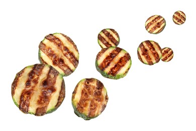 Image of Slices of grilled zucchinis in air on white background