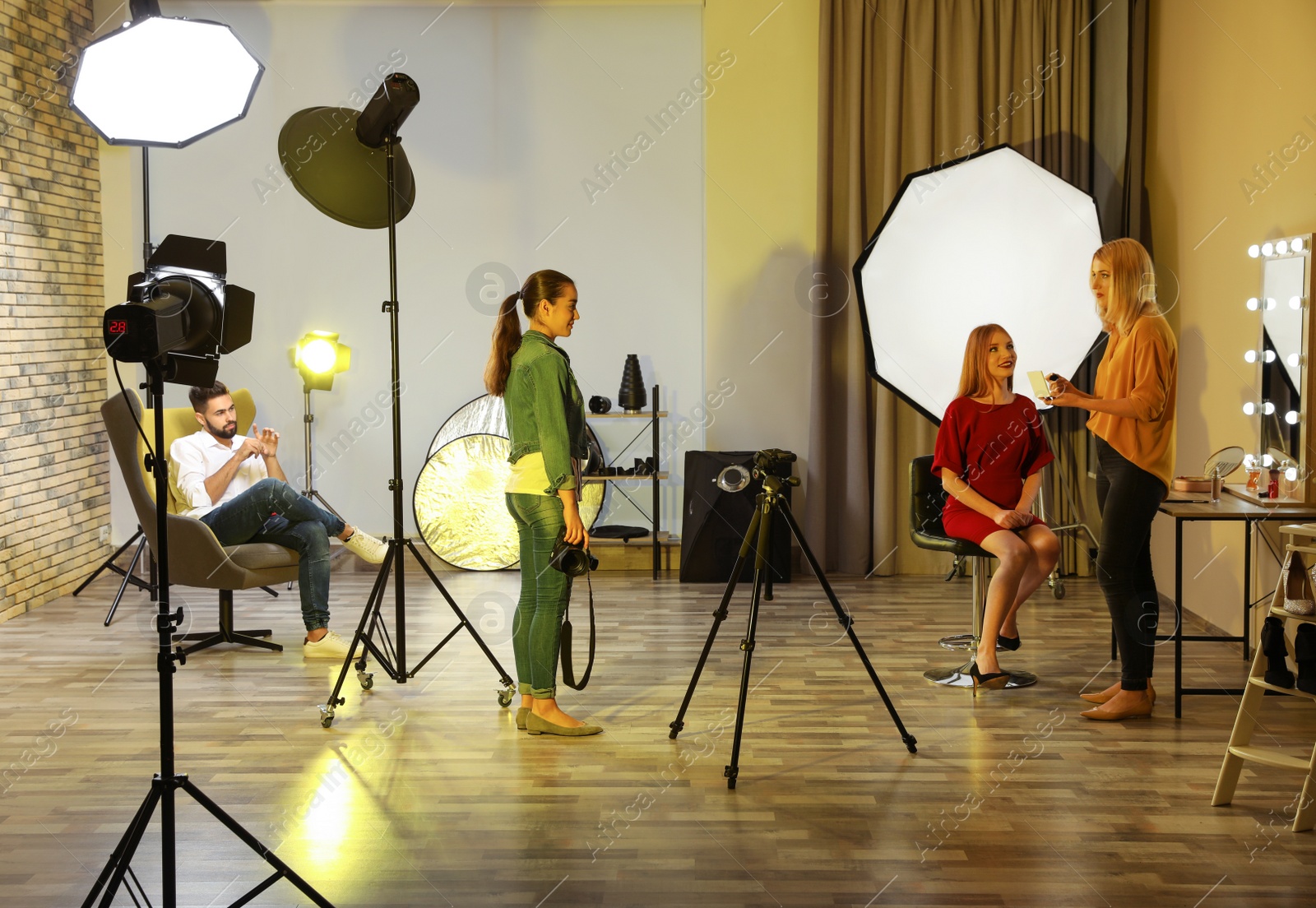 Photo of Photo studio with professional equipment and team of workers