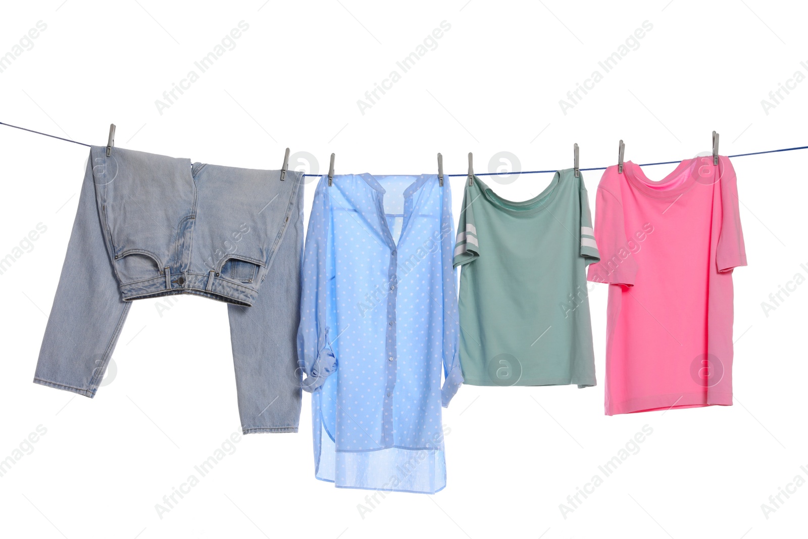 Photo of Different clothes drying on washing line against white background