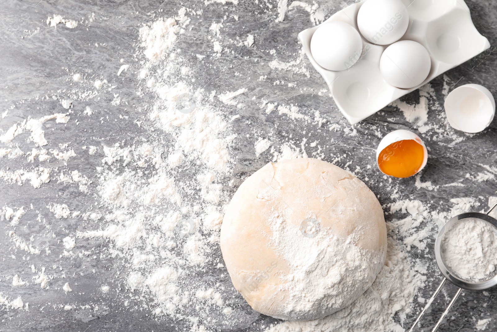 Photo of Flat lay composition with dough on grey table, space for text. Cooking pastries