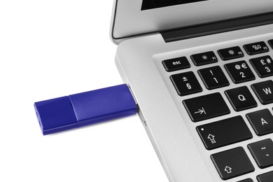 Usb flash drive attached into laptop on white background
