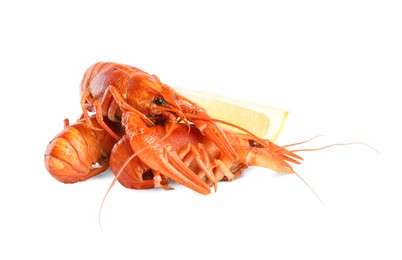 Photo of Delicious red boiled crayfishes with lemon isolated on white