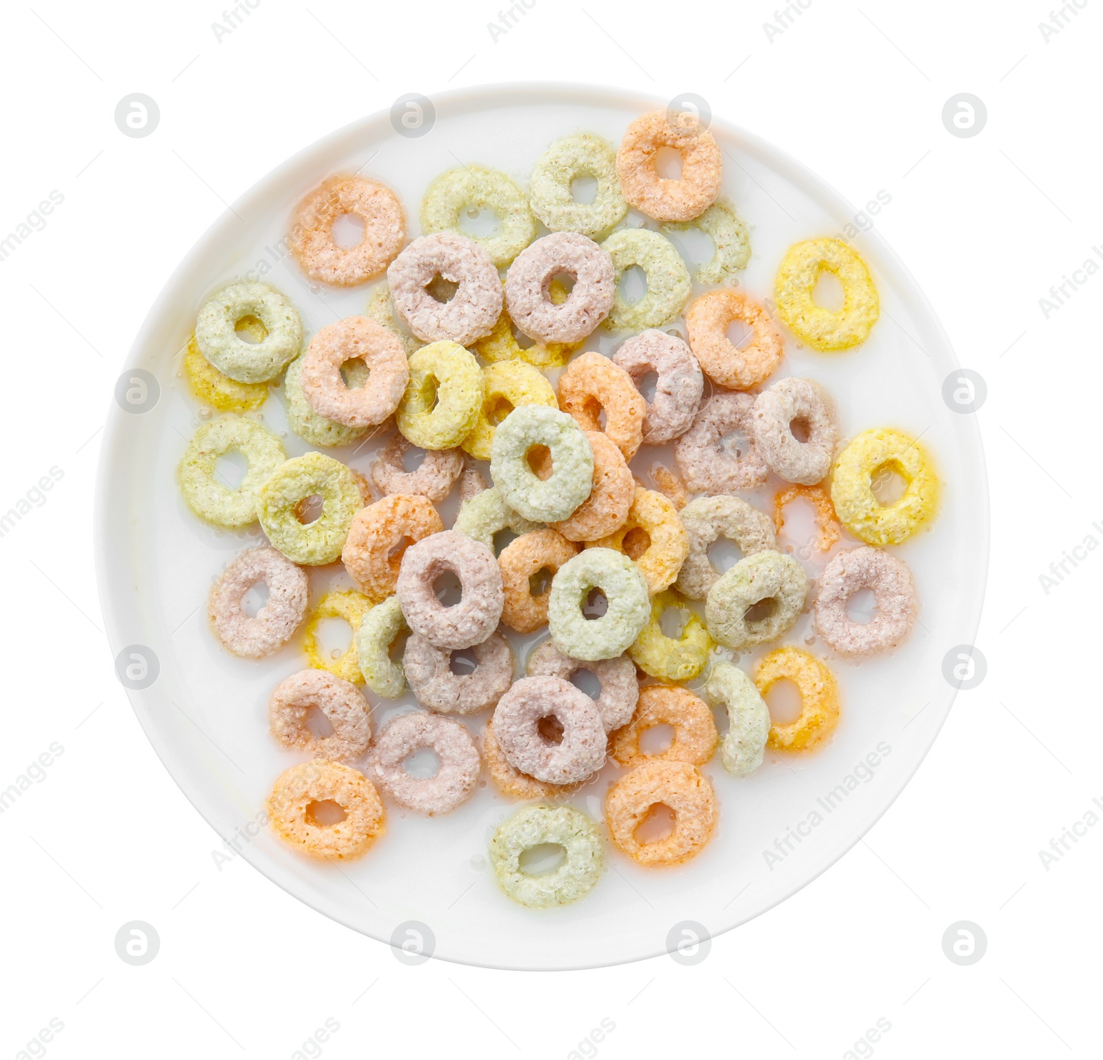 Photo of Tasty colorful cereal rings and milk in bowl isolated on white, top view