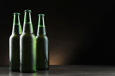 Photo of Many bottles of beer on grey table, space for text