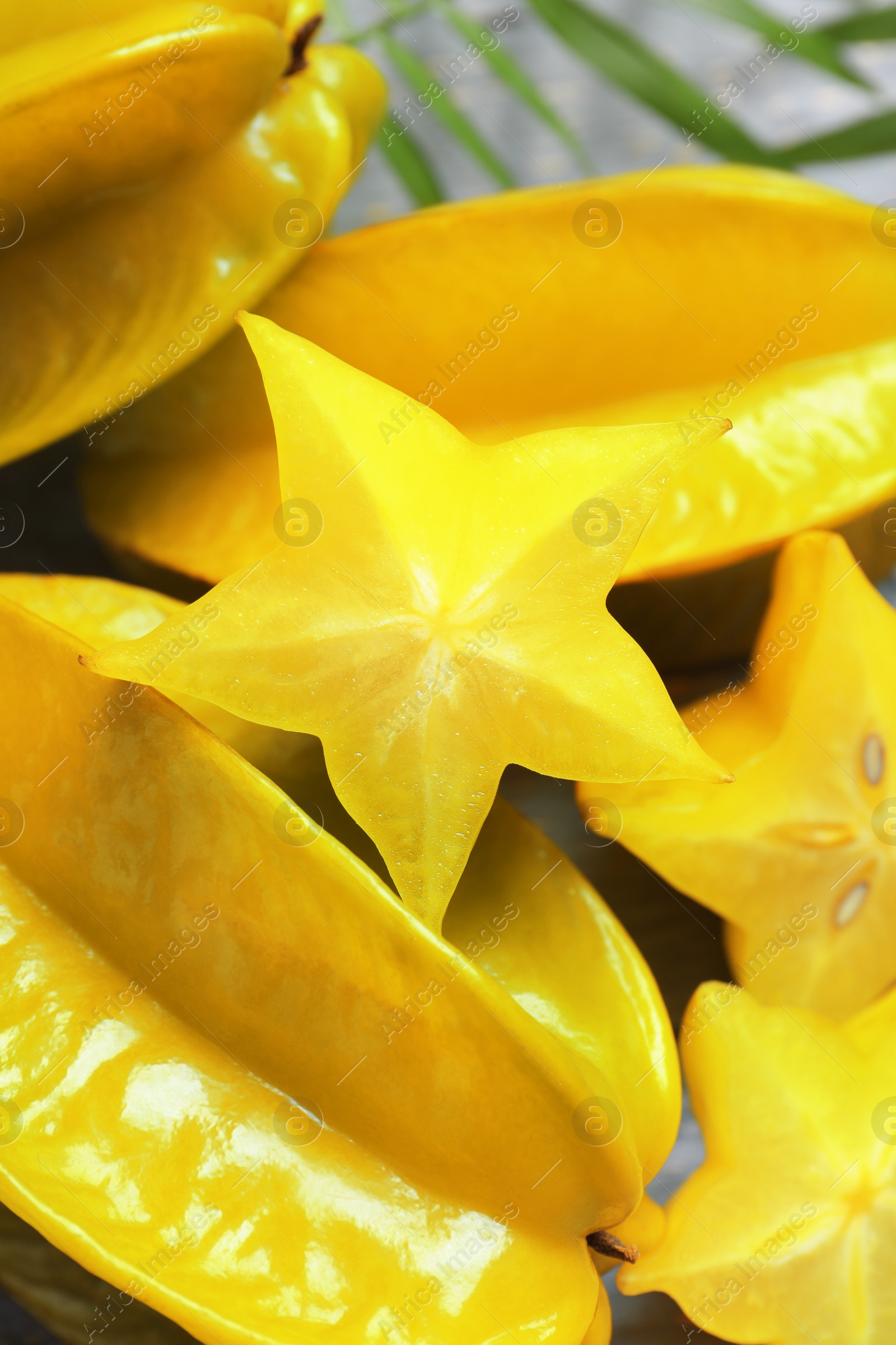 Photo of Delicious carambola fruits and slices on table