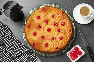 Photo of Flat lay composition with tasty pineapple cake on grey textured table