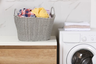 Wicker basket with dirty clothes on counter in laundry room