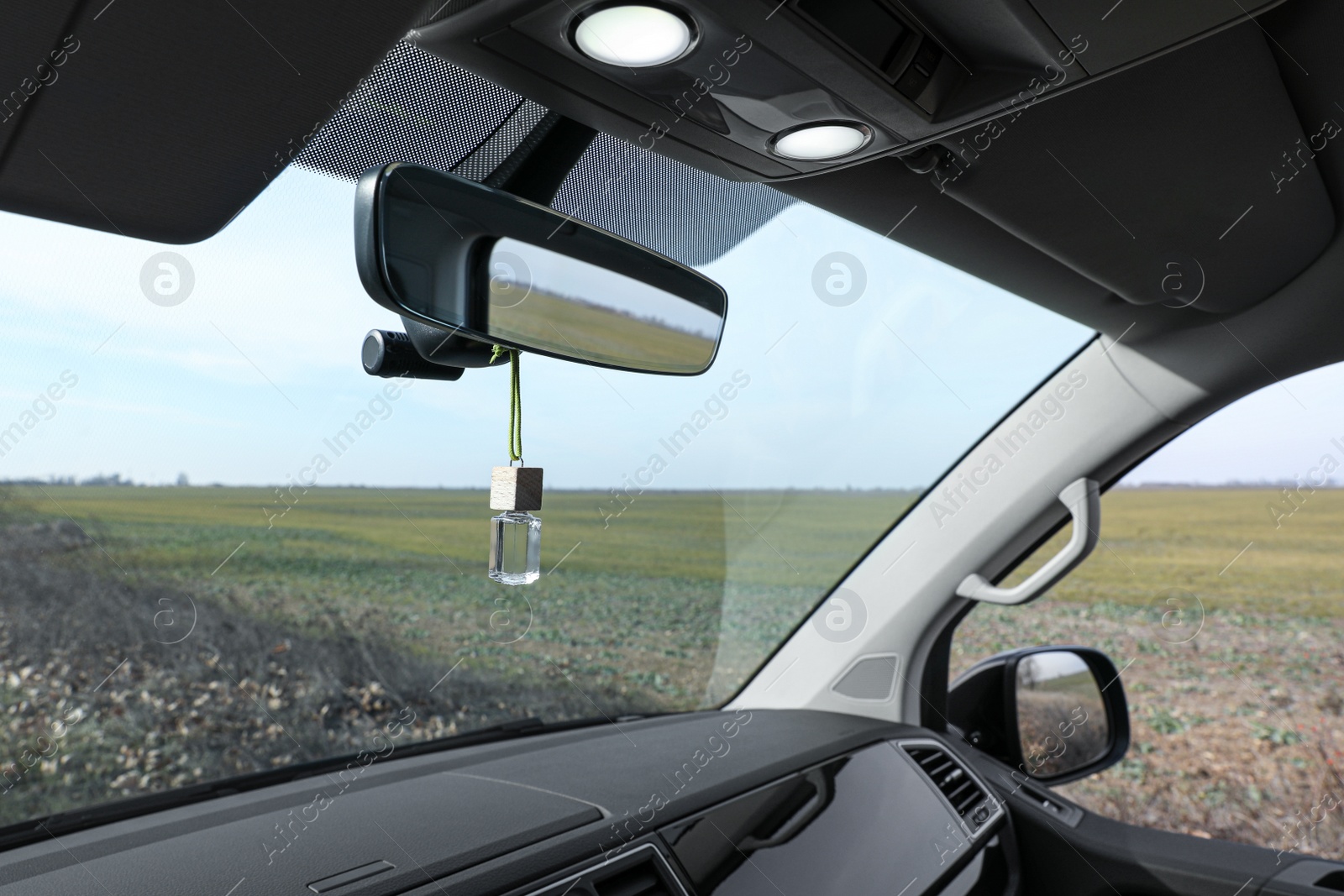 Photo of Air freshener hanging on rear view mirror in car