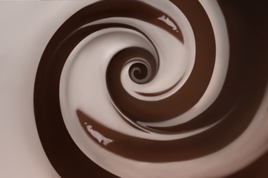 Whirl of delicious melted milk chocolate as background, closeup