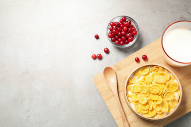 Flat lay composition with tasty corn flakes on light grey table. Space for text