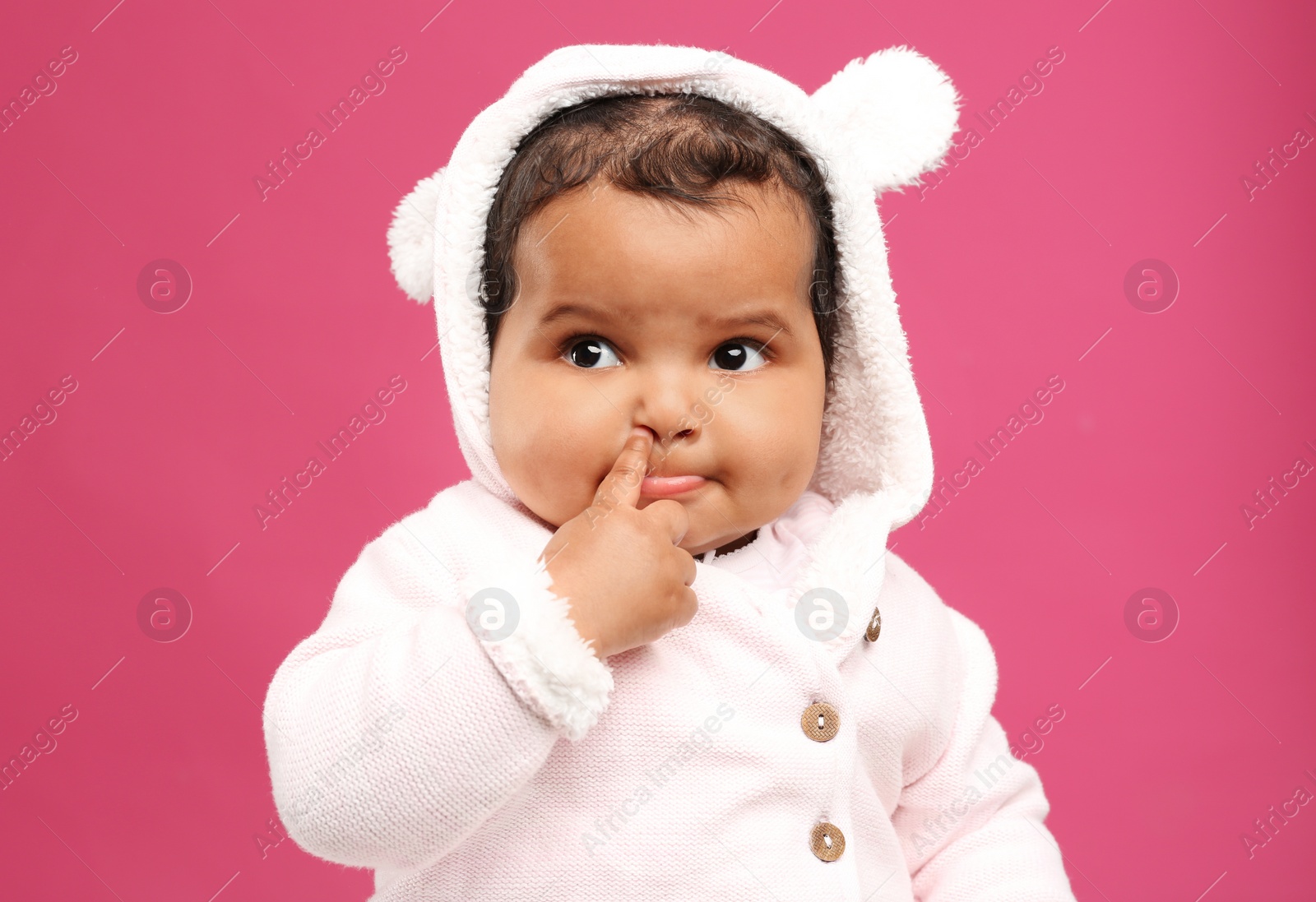 Photo of Cute African American baby on pink background