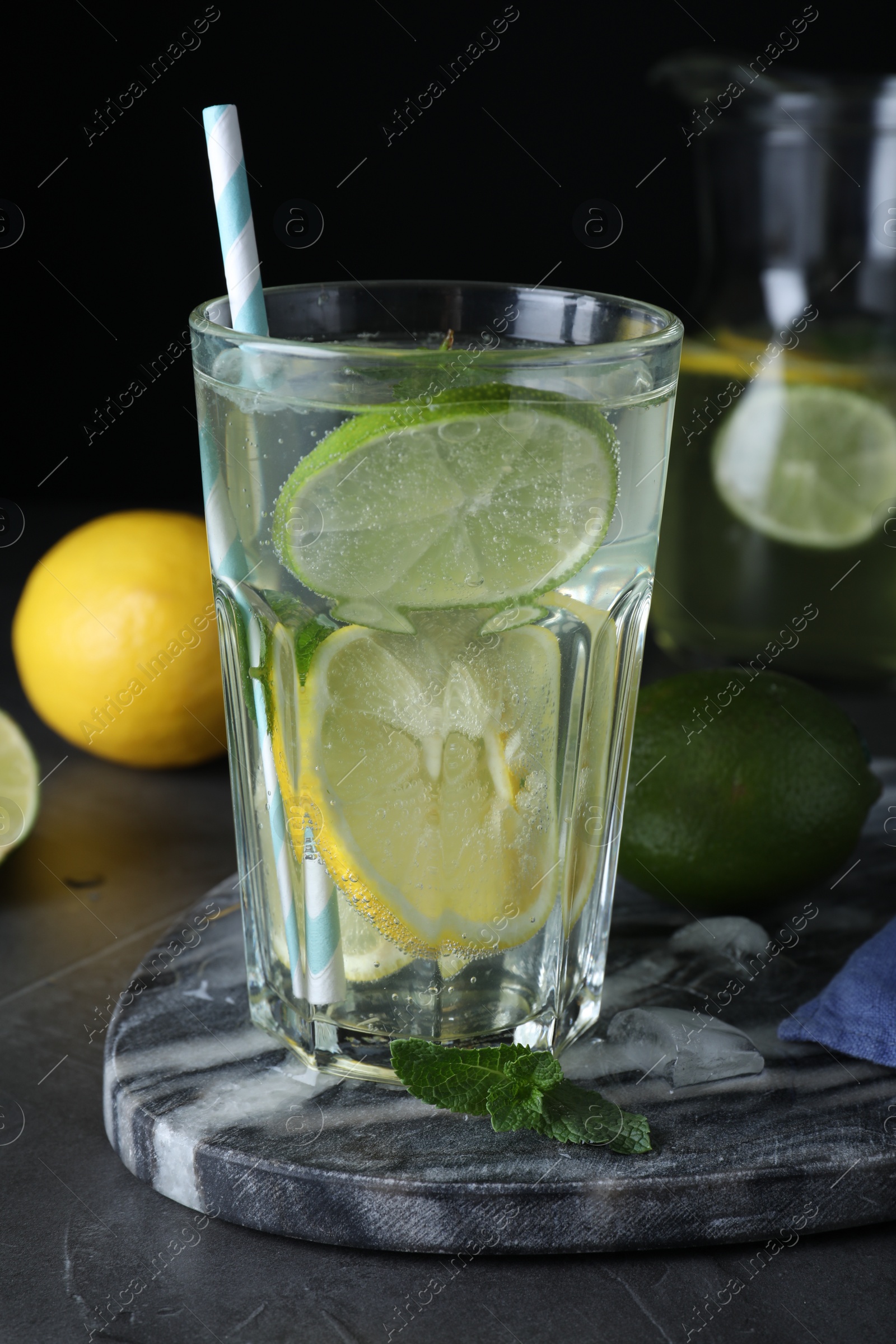 Photo of Delicious lemonade made with soda water and fresh ingredients on grey table