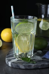 Delicious lemonade made with soda water and fresh ingredients on grey table