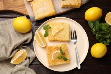 Tasty lemon bars served on wooden table, flat lay