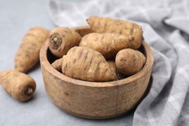 Tubers of turnip rooted chervil on light grey table, closeup