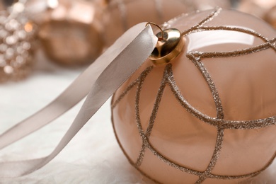 Photo of Beautiful Christmas tree bauble with ribbon on white background, closeup