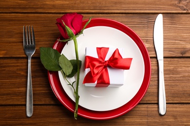 Photo of Beautiful table setting for Valentine's Day dinner on wooden background, flat lay