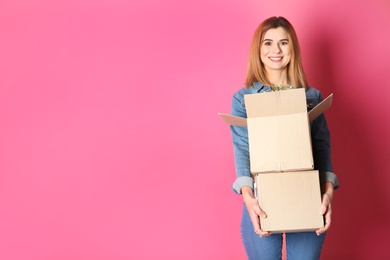 Photo of Woman with moving boxes on color background. Space for text