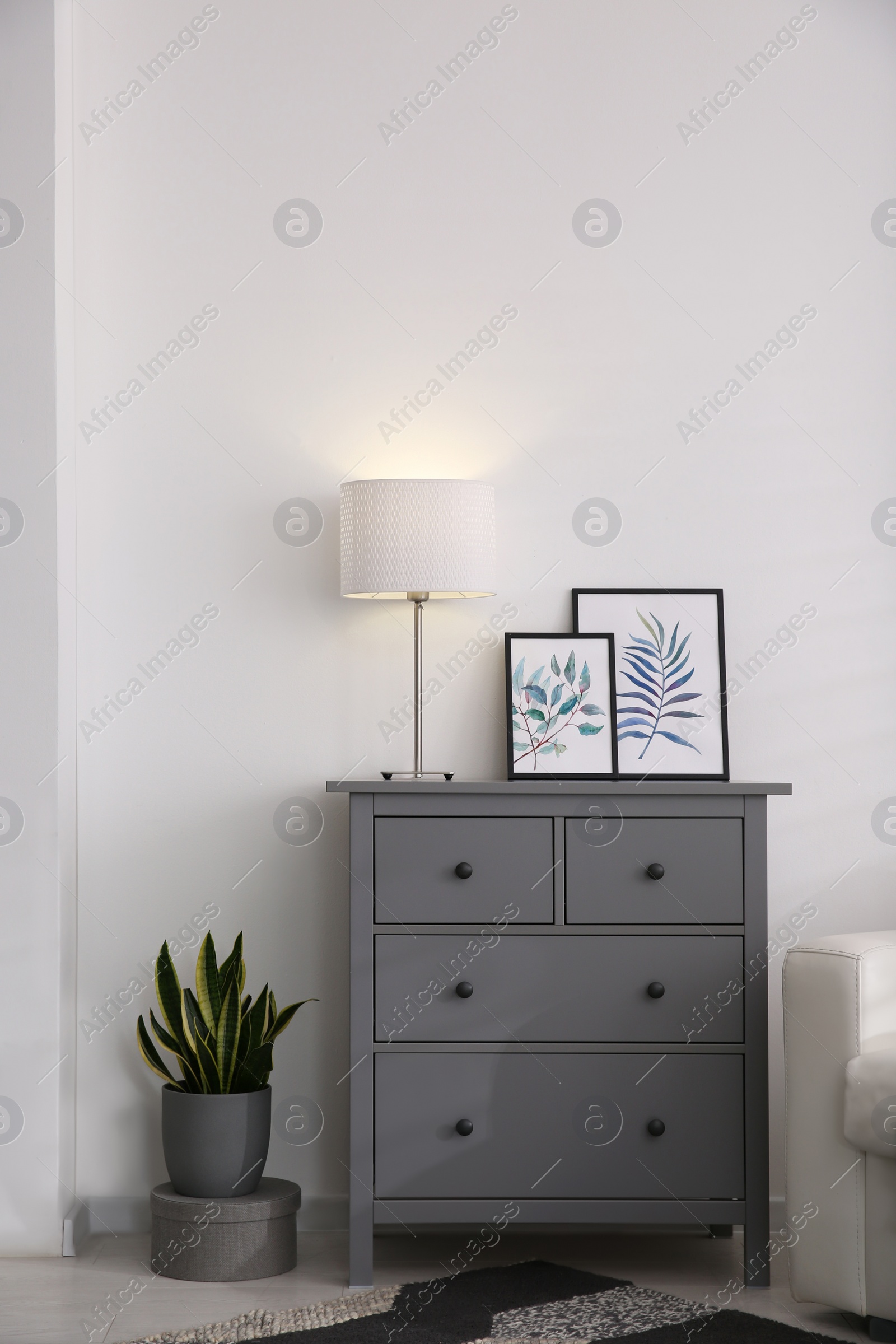 Photo of Modern room interior with grey chest of drawers