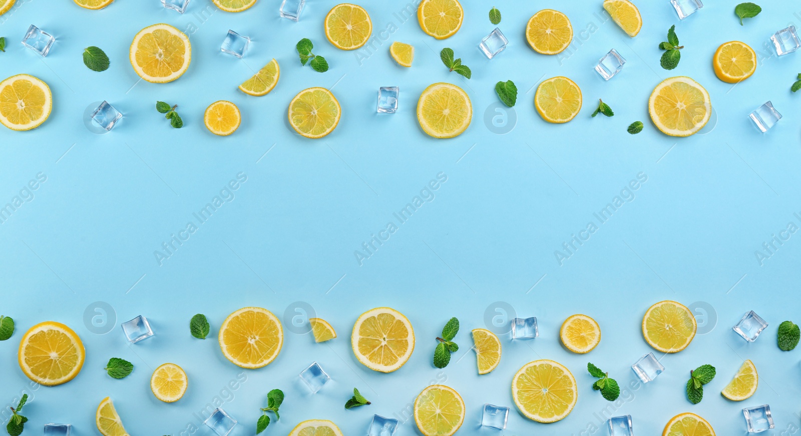 Photo of Frame made of lemon slices, mint and ice on light blue background, top view with space for text. Lemonade layout