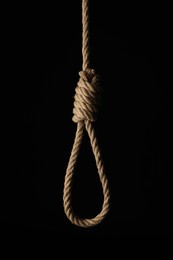 Photo of Rope noose with knot on black background