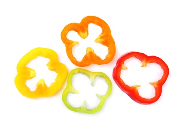 Rings of ripe bell peppers on white background, top view