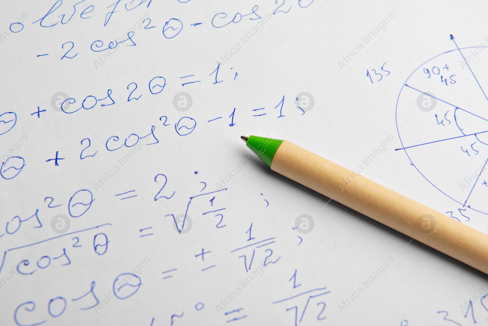 Photo of Paper with written mathematical calculations and pen, closeup