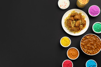 Photo of Traditional Indian food and color powders on black background, flat lay with space for text. Holi festival celebration