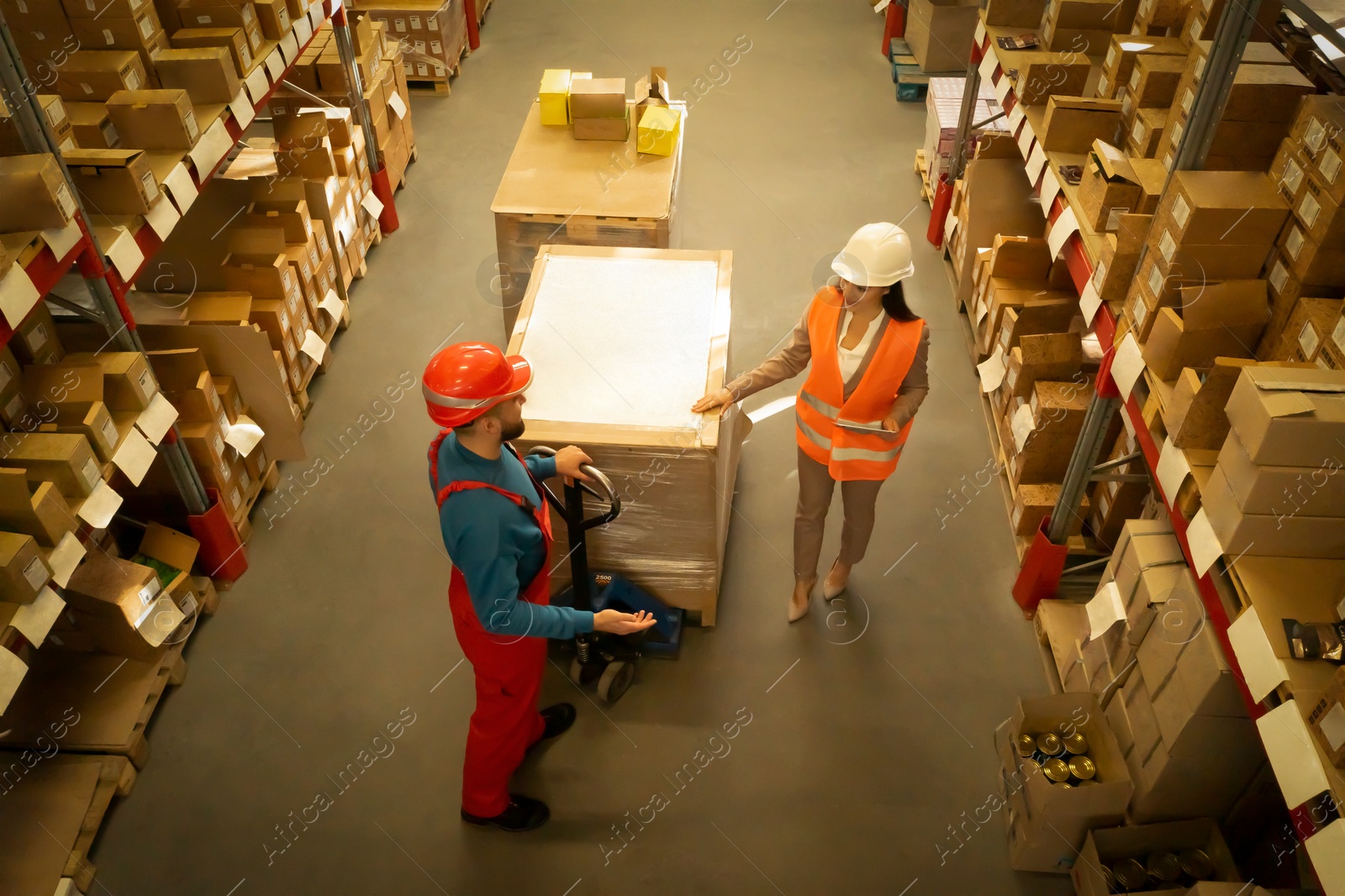 Image of Manager and worker at warehouse, above view. Logistics center