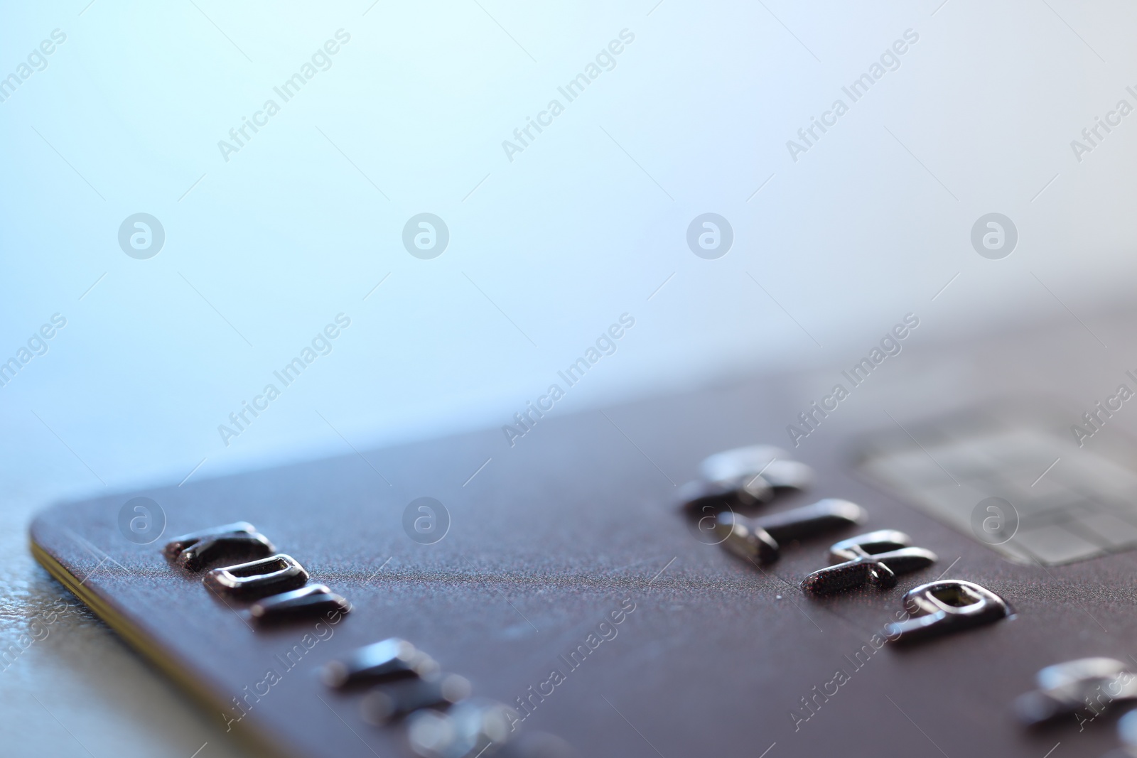 Photo of One credit card on light background, macro view