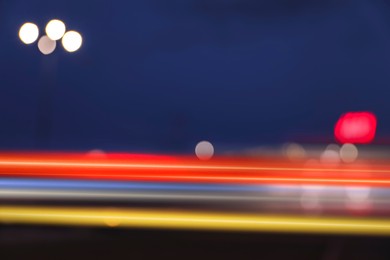 Image of Colorful light trails outdoors, motion blur effect
